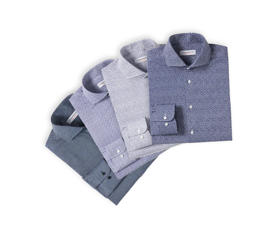 Four TheManRefined Shirts stacked upon one another